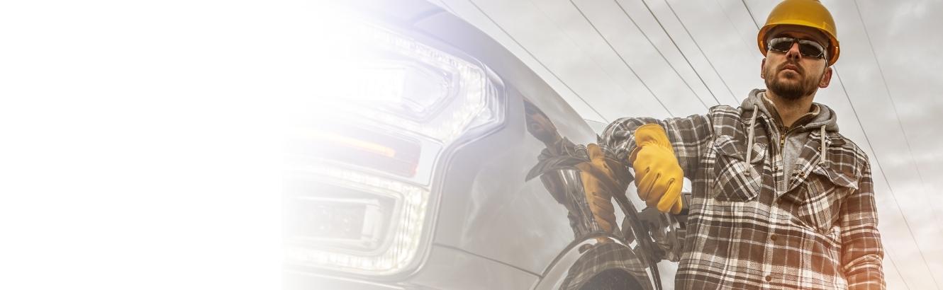 Construction worker standing next to vehicle